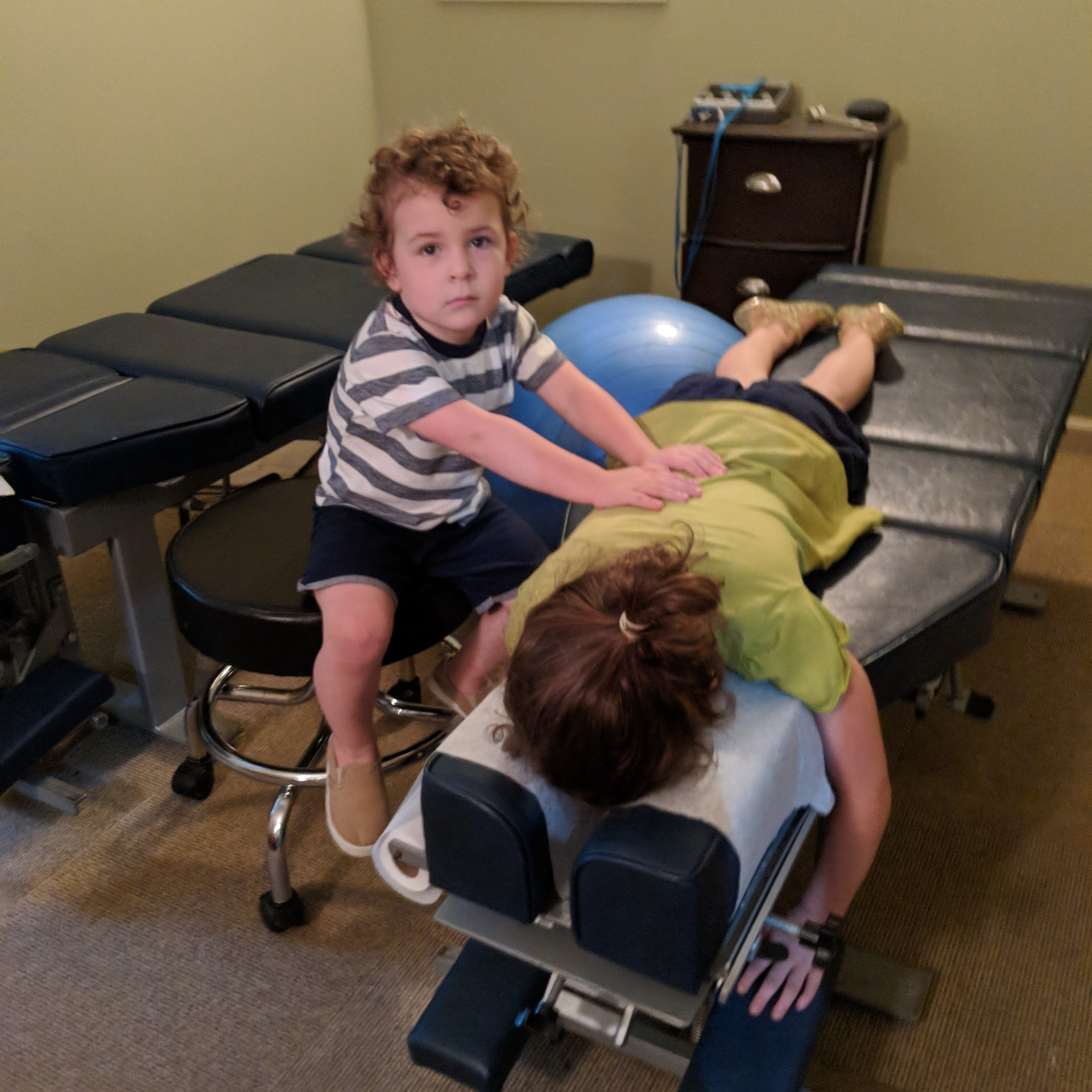 Kids playing on the chiropractic table at home