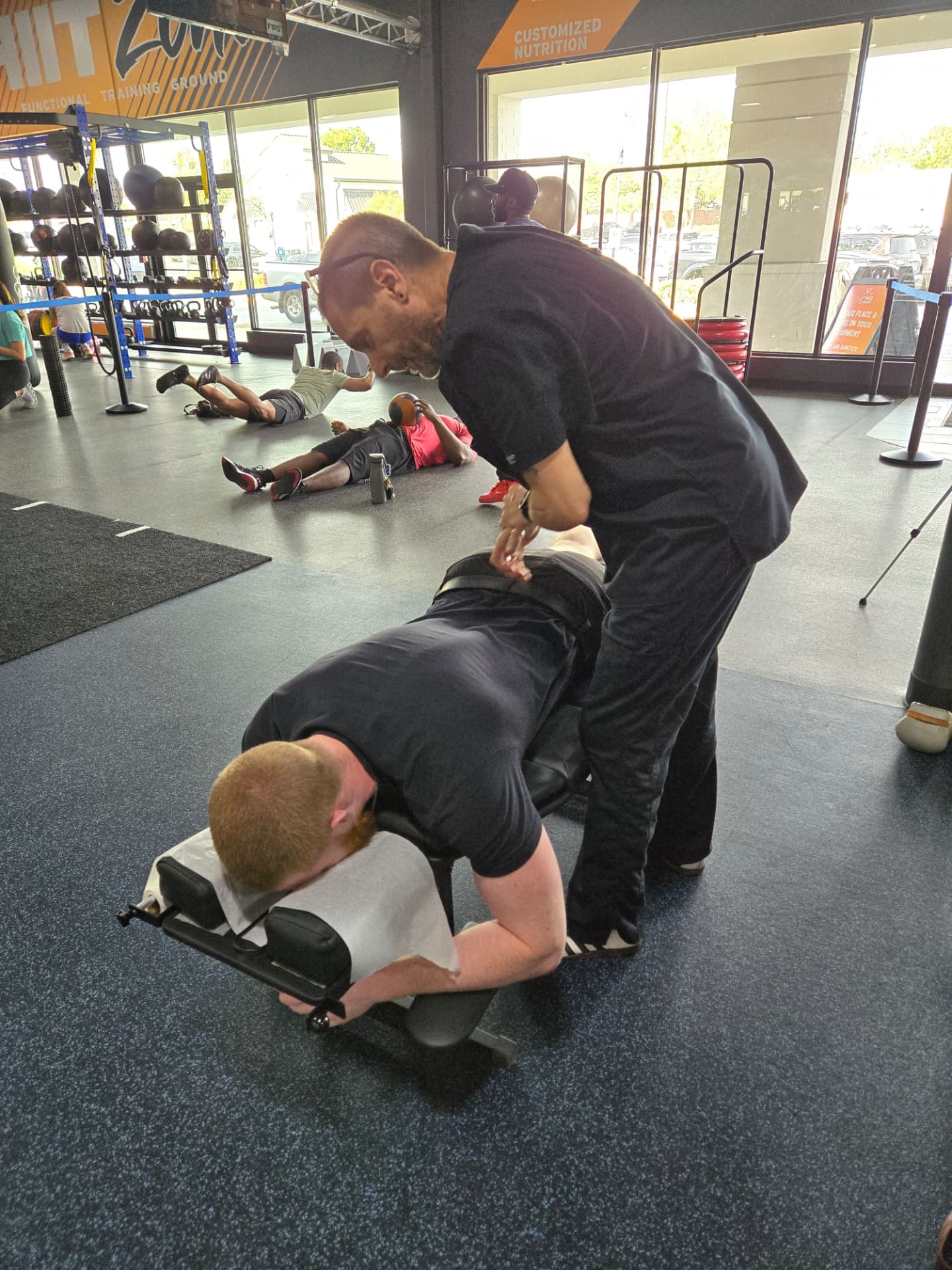 Dr. Steven adjusting an athlete at a local gym